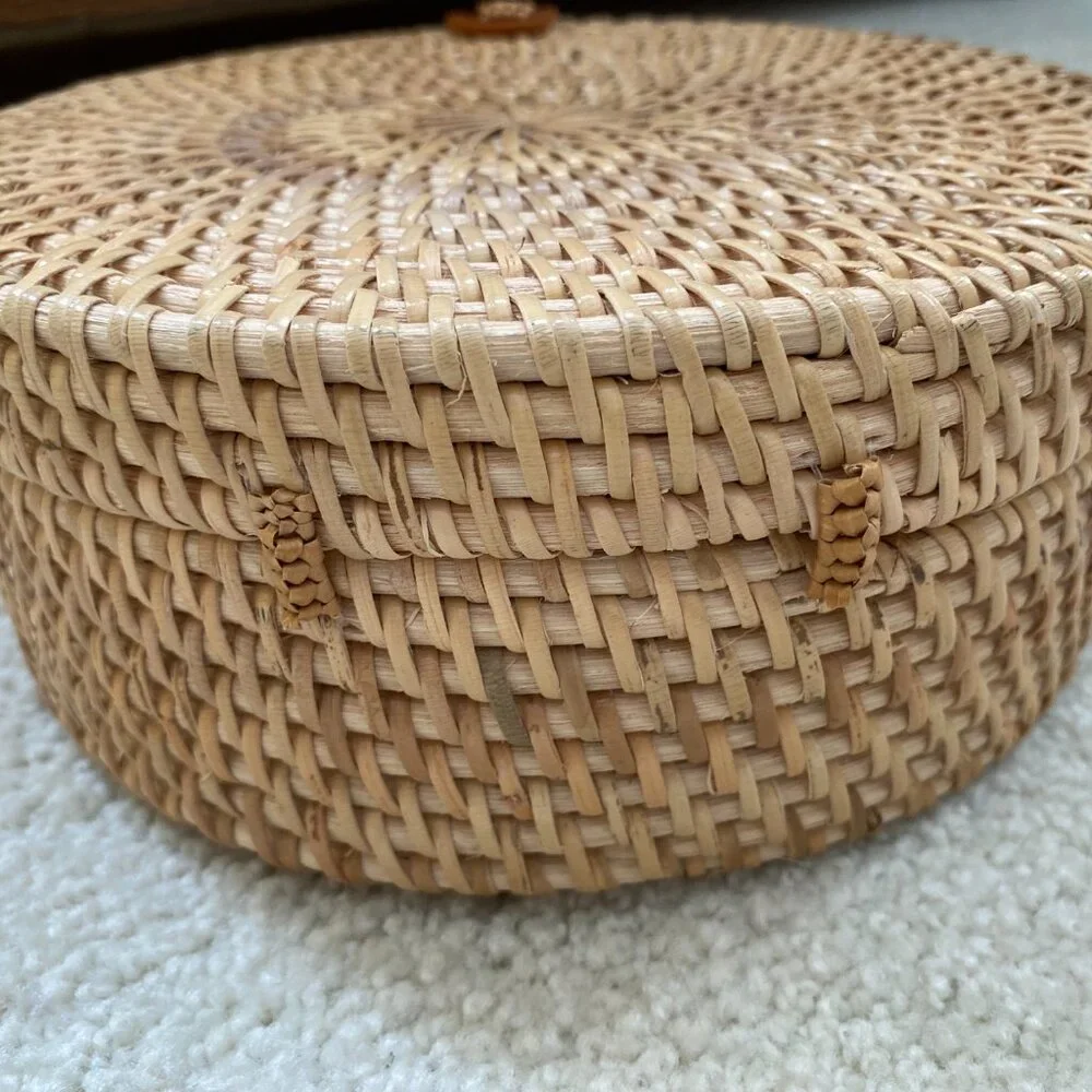 Round solid rattan woven crossbody purse cloth lined, leather accents.